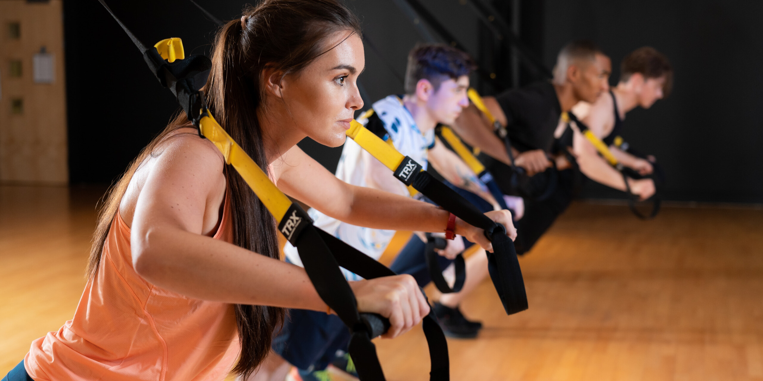 A group fitness class training with the TRX