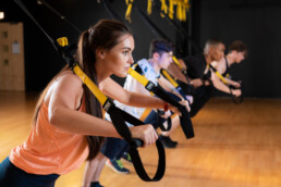 A group fitness class training with the TRX